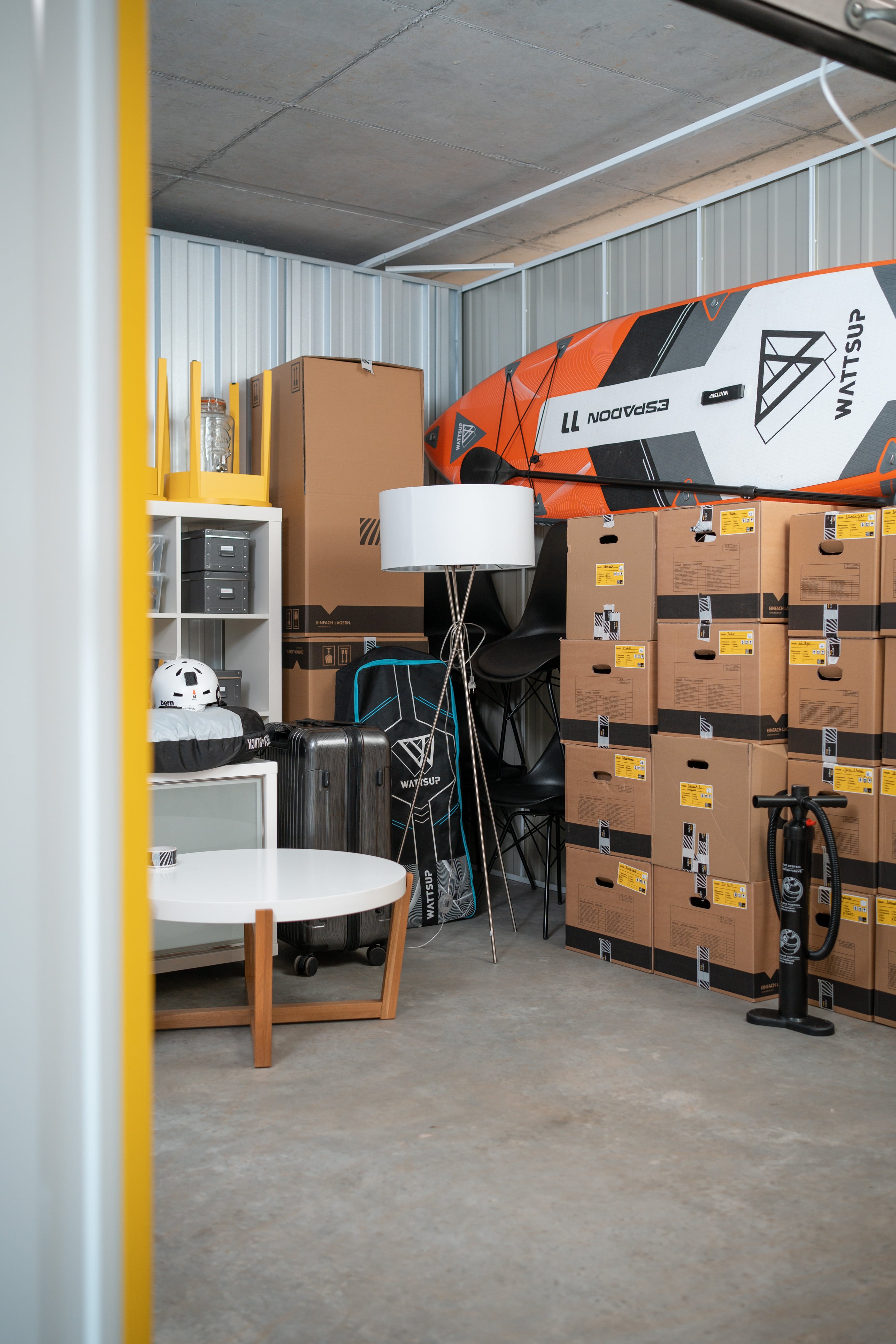 A storage unit at Zebrabox filled with household items, sports equipment and moving boxes.