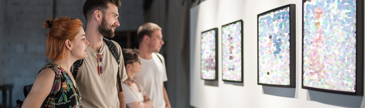 Visitors examine paintings in the showroom