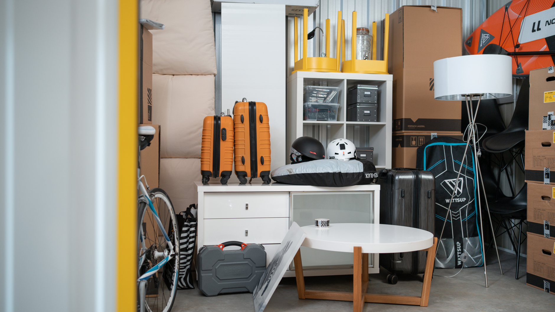 A storage unit at Zebrabox filled with household items, sports equipment and moving boxes.